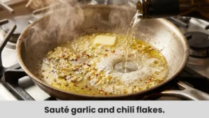 Minced garlic and red pepper flakes sautéing in butter for pasta sauce.
