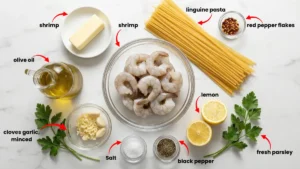 All ingredients for garlic shrimp pasta recipe: shrimp, linguine, garlic, lemon, parsley, parmesan, butter, and olive oil.