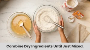 Combining all-purpose flour, baking soda, and salt in a separate bowl for chocolate chip cookie dry mixture