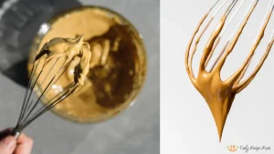 Hand whisking whipped coffee until it forms light brown, fluffy peaks with a ribbon consistency.