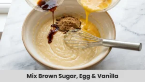 Brown sugar, beaten egg, and vanilla extract mixed into banana bread batter