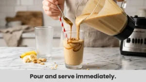 Pouring a thick and creamy Peanut Butter Banana Smoothie into a tall glass with a drizzle of peanut butter on top, ready to serve fresh.