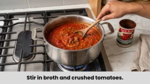 Simmering rich tomato and beef broth mixture for creamy lasagna soup recipe with cottage cheese