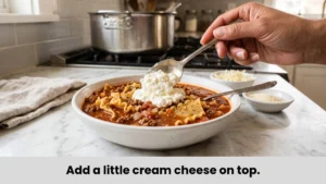 Topping lasagna soup with creamy cottage cheese dollop and melted mozzarella cheese