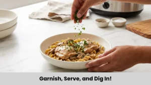Creamy chicken stroganoff over egg noodles garnished with fresh parsley and ready to serve.